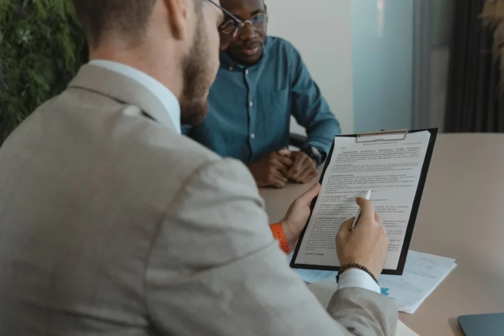 Recruiter reviewing a candidate's documents during a job interview