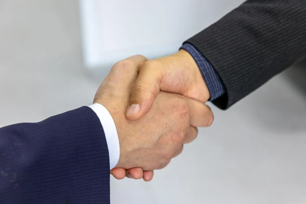 Business handshake showing the benefits of using a staffing agency