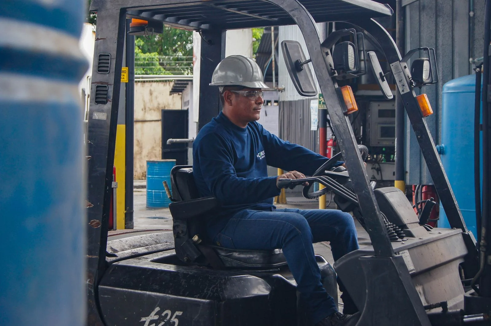 Worker in protective gear driving a forklift, one of many forklift operator jobs