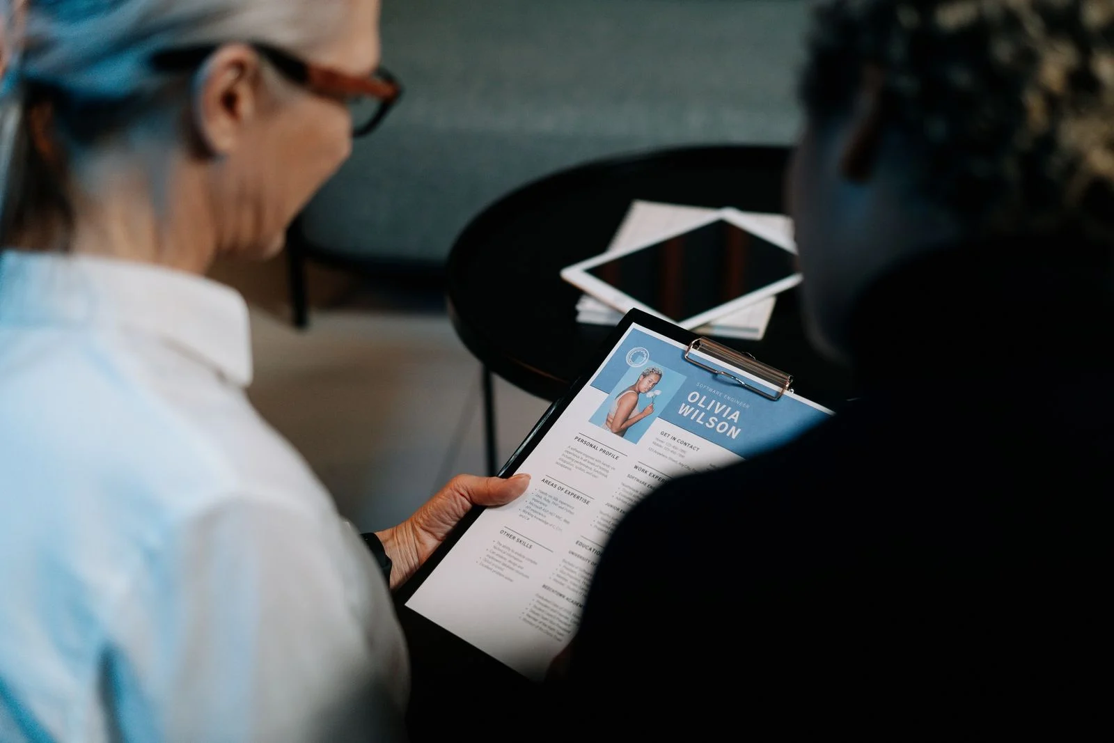 Interviewers reviewing a resume, working to avoid hiring mistakes