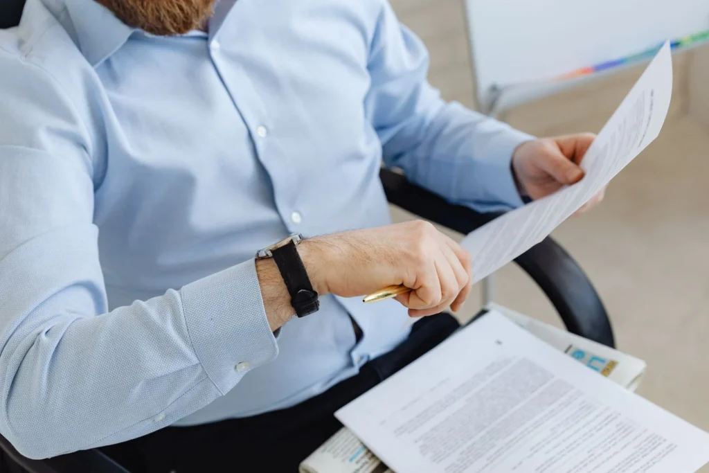 Manager reviewing paperwork to avoid hiring mistakes