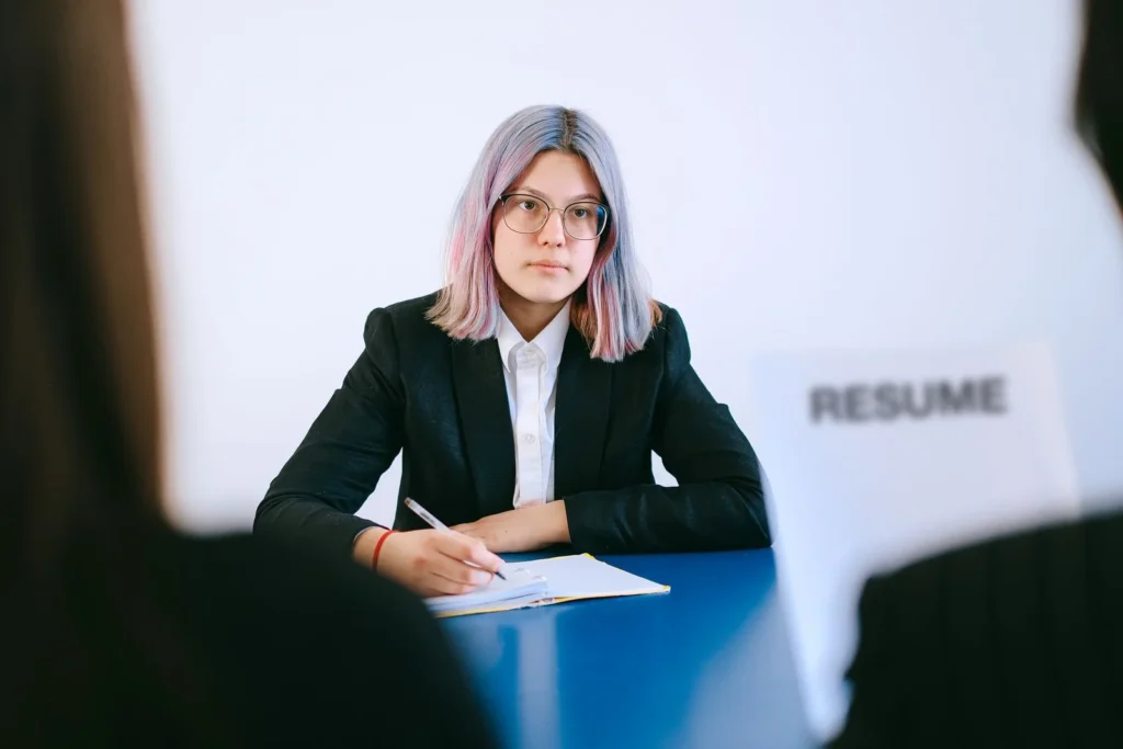 Candidate taking notes, following job interview tips in an office