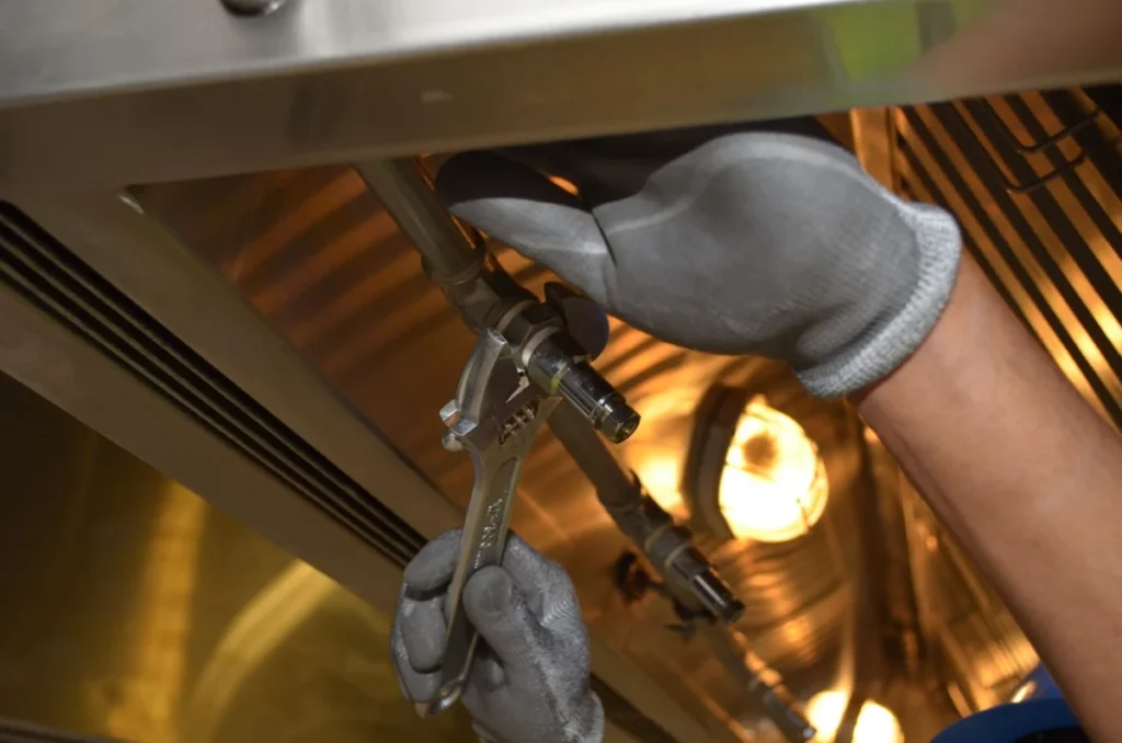 Worker fixing pipes, a common task in maintenance technician jobs