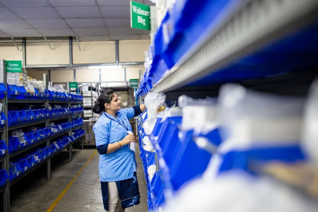 Worker organizing inventory shelves during seasonal staffing peaks