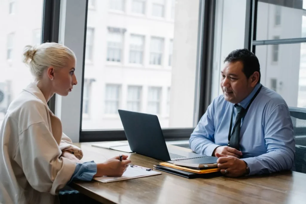 Employer comparing temp agency vs direct hire options with a recruiter