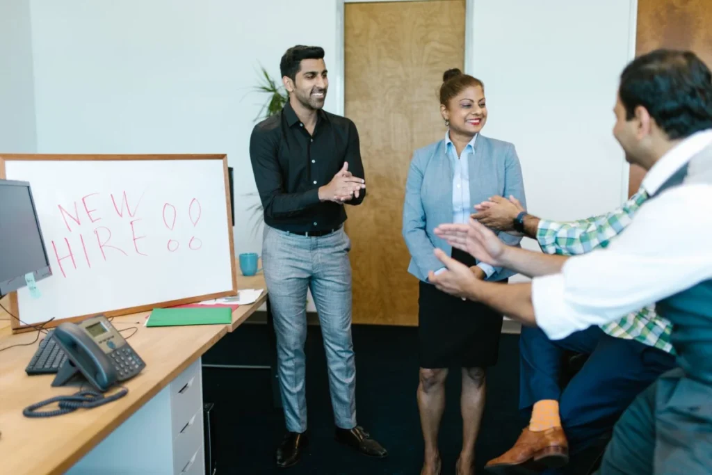 Team welcoming a new hire after temp to hire jobs turn permanent