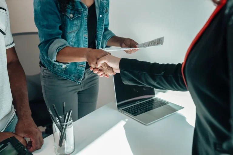Employer and new hire shaking hands after choosing between temp agency vs direct hire