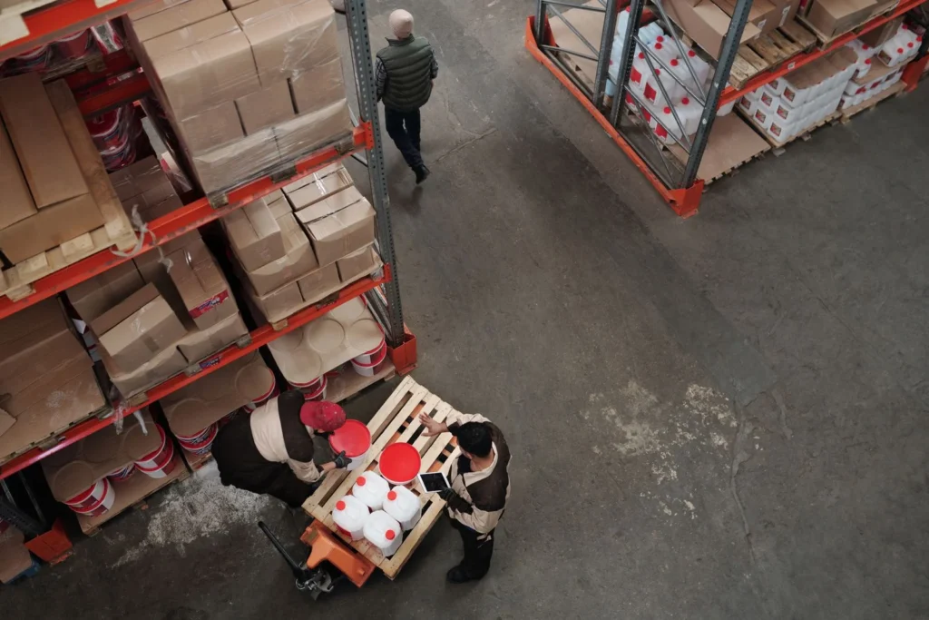 High angle view of warehouse workers handling inventory and logistics operations