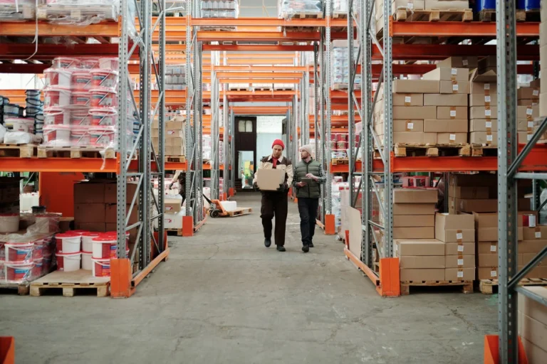 Two workers managing inventory during warehouse jobs in St. Paul